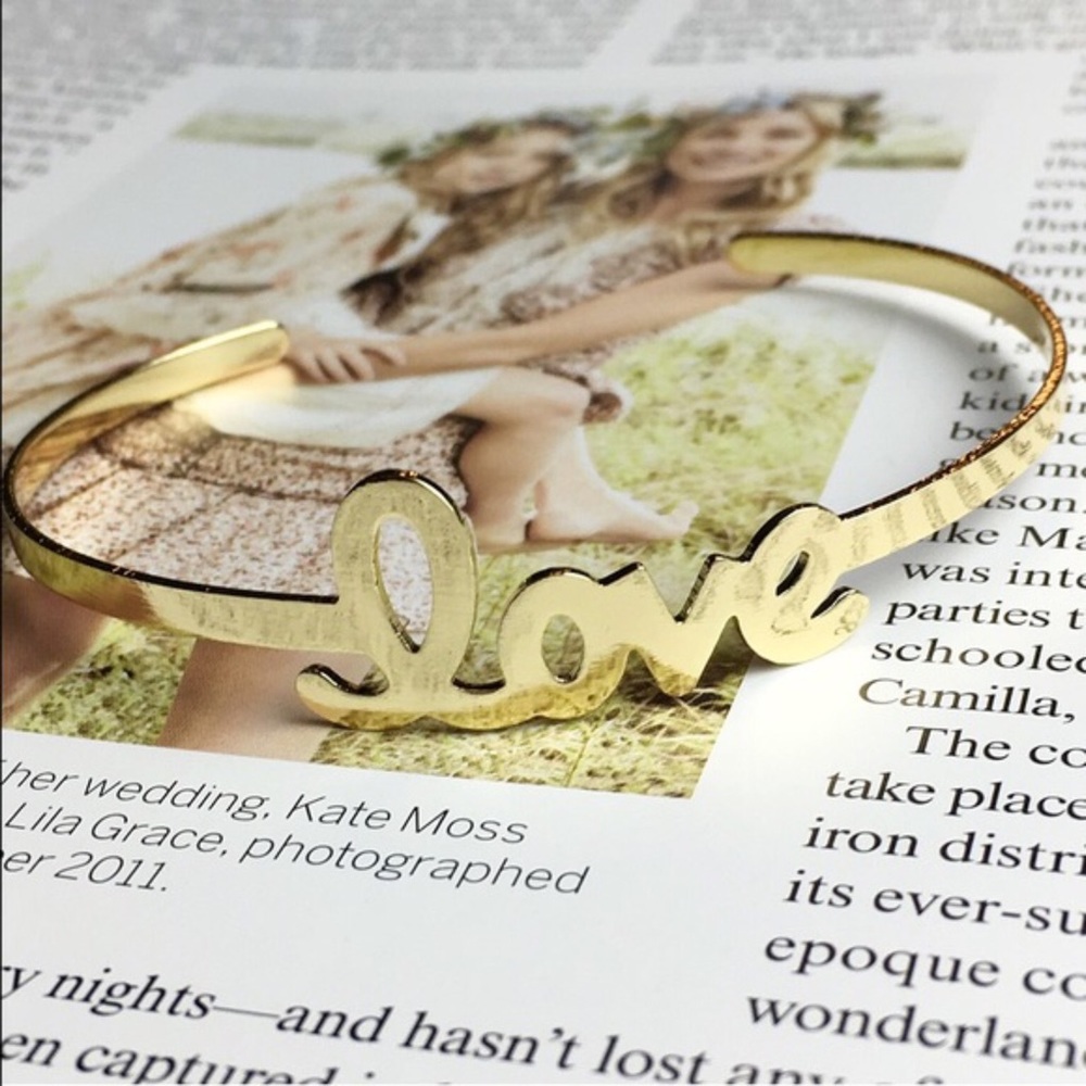 “Love" gold simple stylish cuff bracelet written in cursive. Perfect gift